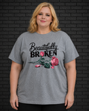 Plus size model wearing grey crew neck shirt with Beautifully Broken design