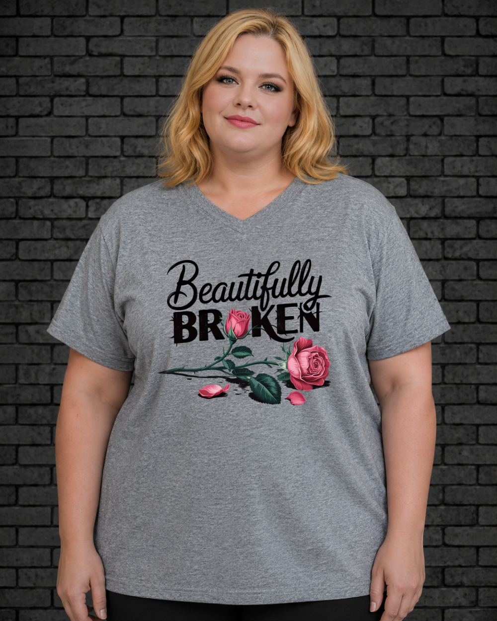 Plus size model wearing grey v neck shirt with Beautifully Broken design