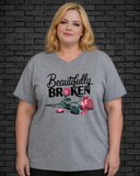 Plus size model wearing grey v neck shirt with Beautifully Broken design
