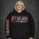 Plus size model wearing a black oversized hoodie saying Just One More Chapter